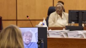 Monet Carter-Mixon, sister of Manny Ellis testifying during the trial of Tacoma Police Officers Christopher Burbank, Matthew Collins and Timothy Rankine in the killing of Manny Ellis at Pierce County Superior Court , Thursday, Oct. 5, 2023, in Tacoma, Wash. A photo of her brother Manny Ellis is seen in the foreground.