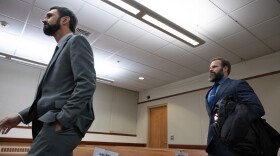 Tacoma police officers Christopher “Shane” Burbank (left) and Matthew Collins arrive in Pierce County Superior Court in Tacoma, Wash., on Wednesday, Dec. 20, 2023.