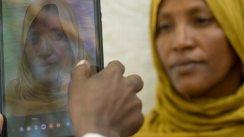 Fatouma Zahara Hasan, a widow with a large family from the town of Chifera, has her photograph taken on a tablet as part of a vast registration drive to ensure that food aid funded by the United States in parts of Ethiopia is only provided to recipients that qualify.  