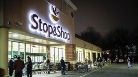 FILE: Customers wait in line at a Stop & Shop supermarket that opened special morning hours to serve people 60-years and older due to coronavirus concerns, Friday, March 20, 2020, in Teaneck, N.J. For most people, COVID-19, the disease caused by the new coronavirus, causes only mild or moderate symptoms, such as fever and cough. For some, especially older adults and people with existing health problems, it can cause more severe illness, including pneumonia.