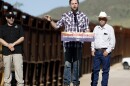 Republican vice presidential nominee Sen. JD Vance of Ohio delivers remarks alongside rancher John Ladd (right) and Paul A. Perez, president of the National Border Patrol Council, as Vance tours the U.S. Border Wall on Thursday in Montezuma Pass, Ariz. Vance is visiting the border on the final stop of his first visit to the Southwest as a vice presidential candidate. 