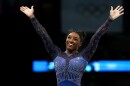 Simone Biles reacts after the balance beam portion of the women's gymnastics individual all-around competition at the Paris Olympics on Thursday. She's now won six Olympic gold medals — the most of any U.S. gymnast.