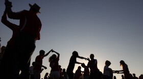 FILE - Tailgaters dance the Cajun two step to the Gino Delafose and French Rockin' Boogie zydeco band as a kickoff for the annual Festival Acadiens et Creoles in Lafayette, La., Oct. 8, 2010.