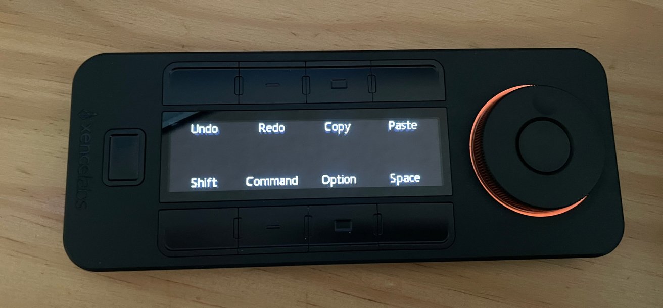 Black control panel with buttons labeled Undo, Redo, Copy, Paste, Shift, Command, Option, Space, and a large orange dial on the right.