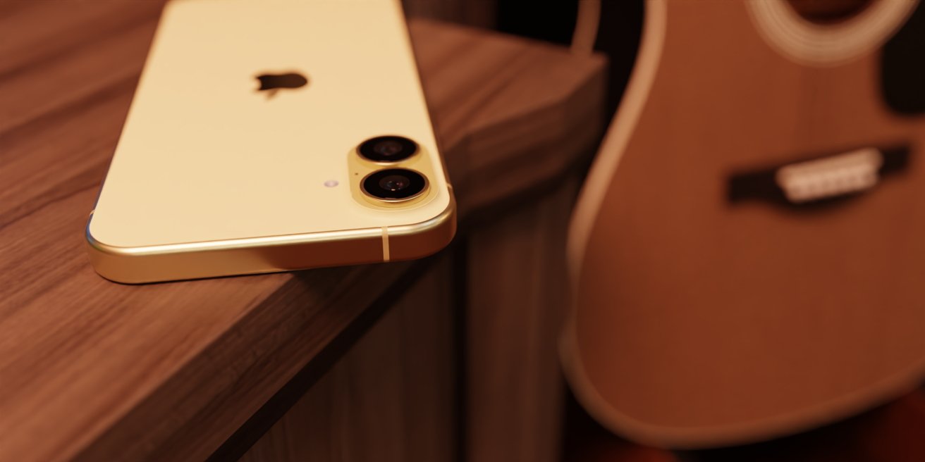 Yellow smartphone with dual cameras lying on a wooden surface, next to an acoustic guitar.