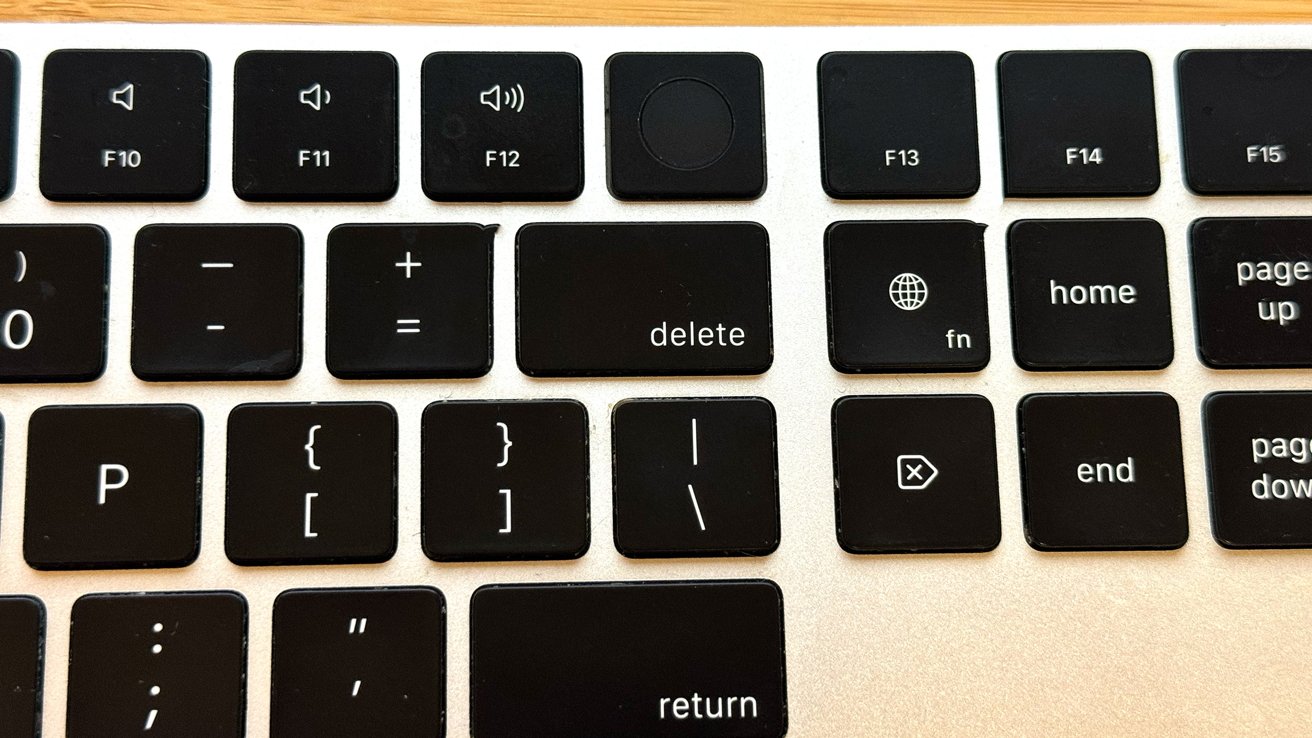 Close-up of a keyboard section showing keys including F10 to F15, delete, home, end, return, and volume controls. Nearby keys include brackets, plus, equals, and other symbols.