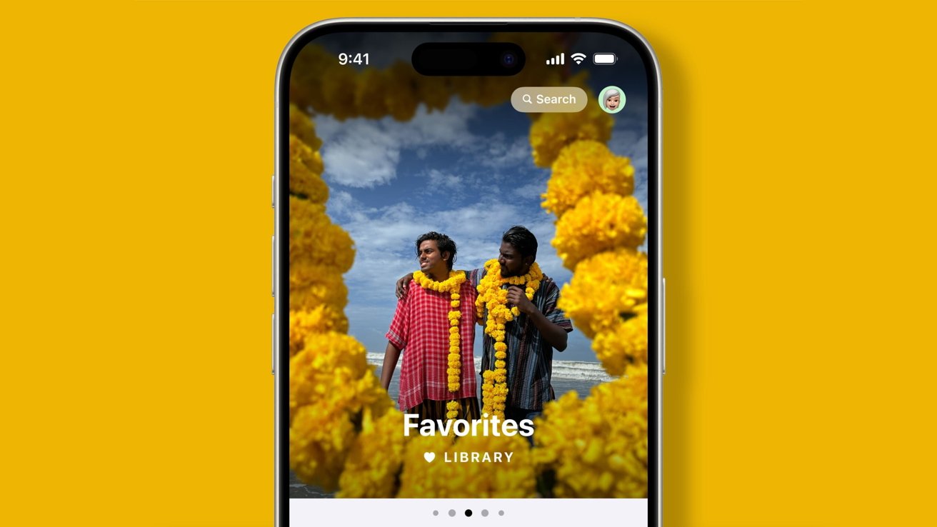 Two people wearing yellow flower garlands stand on a beach, displayed on an iPhone screen with a yellow background.