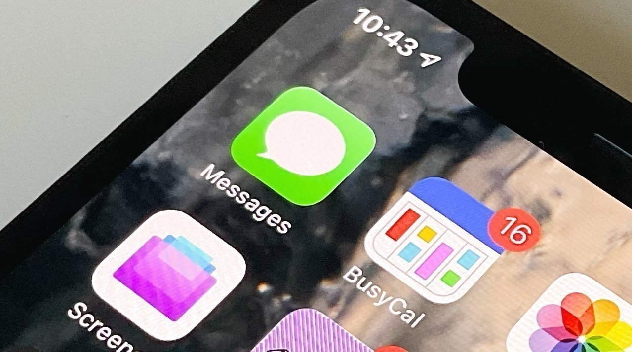 Close-up of a smartphone screen showing the time 10:43, with app icons for Messages, BusyCal (16 notifications), Screens, and Photos.