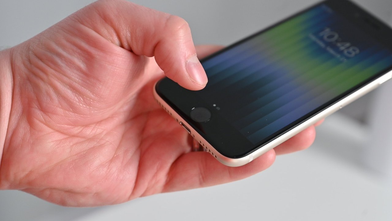 A hand holding a smartphone showing a colorful lock screen with time displayed at 10:48.