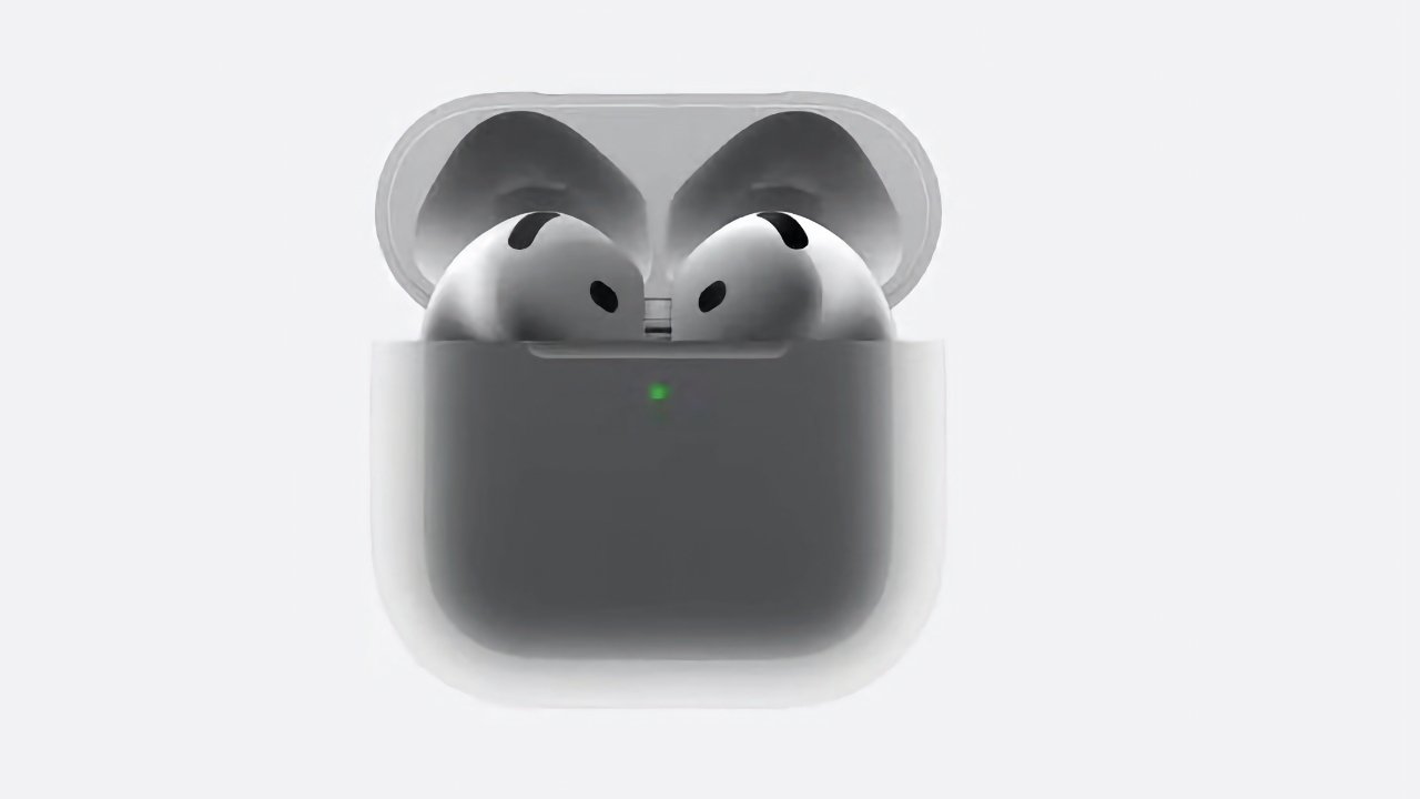 Two wireless earbuds inside an open charging case with a visible green light indicator.