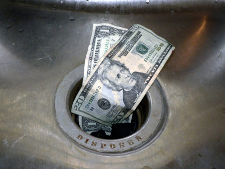 money-down-the-drain-shutterstock_1703333