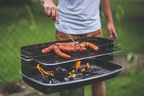 man grilling meat