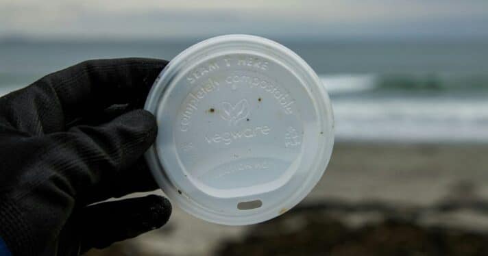 A closeup of a compostable coffee cup lid