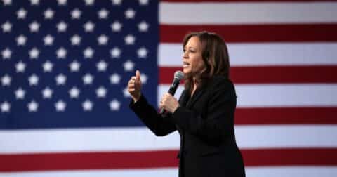 Kamala Harris in front of an American flag background.