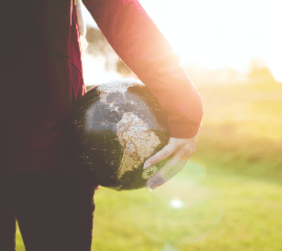 This is an image of a person holding a globe