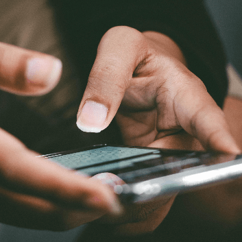 This is a picture of a man typing on a phone