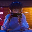 A gamer concentrating hard as he plays on the Xperia 1 V 