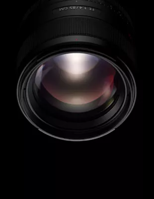 The end of a Sony Alpha lens is seen on a black background