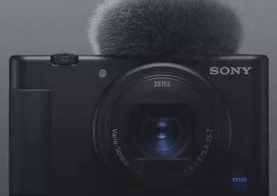 Front view of black Sony compact camera with microphone attached