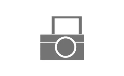 A grey icon of a camera with a flip screen.