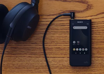 Portable Audio Player on Desk with Headphones