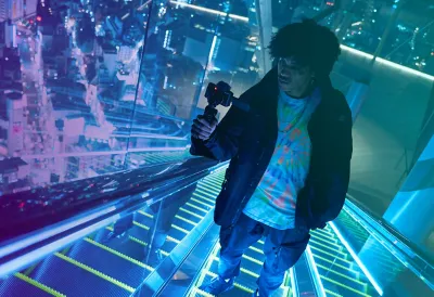 Man taking video of night view in a high-rise building