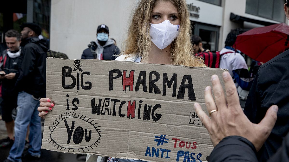 Архив: женщина с плакатом "Big pharma следит за вами" на кции протеста против вакцинных паспортов в Париже, Франция, август 2021 г.