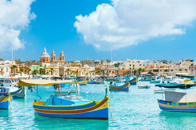 <p>Boats bobbing in Marsaxlokk harbour</p>