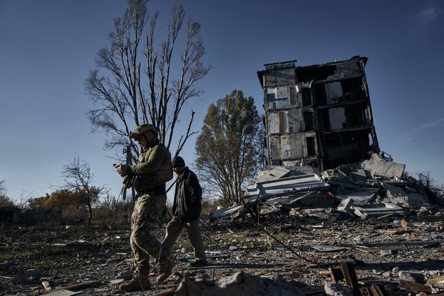 <p>A police officer convinces a resident to evacuate his home amid intense fighting in Avdiivka, Ukraine</p>