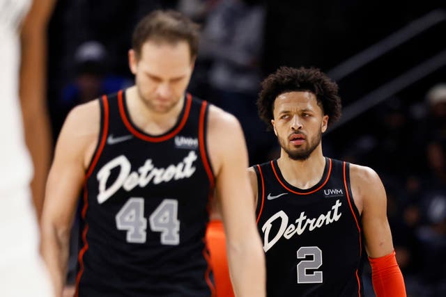 Detroit Pistons forward Bojan Bogdanovic and guard Cade Cunningham return to the court (Duane Burleson/AP)