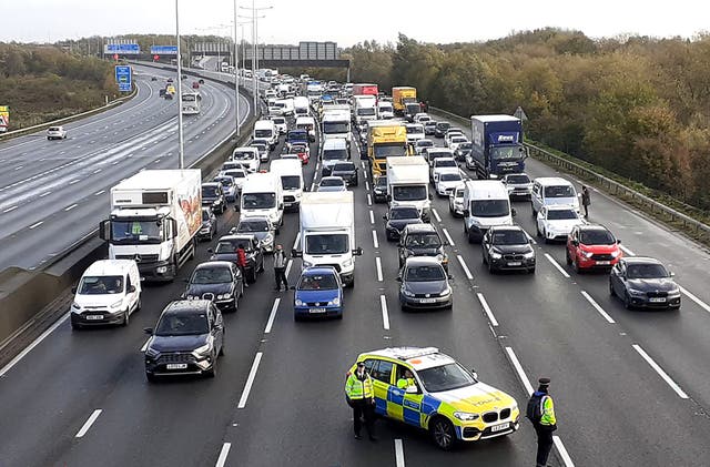 <p>Police closing the M25, where demonstrators from Just Stop Oil climbed a gantry in 2022</p>