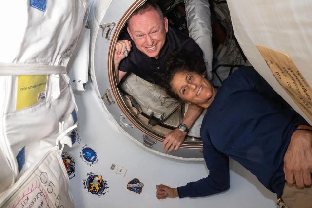 <p>Nasa astronauts Butch Wilmore and Suni Williams pose on 13 June 13 2024 inside the vestibule between Boeing’s Starliner spacecraft</p>