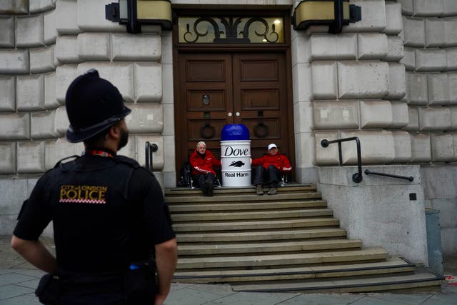 <p>Greenpeace protesters have staged a demonstration outside Unilever’s London headquarters (Kristian Buus/Greenpeace/PA)</p>