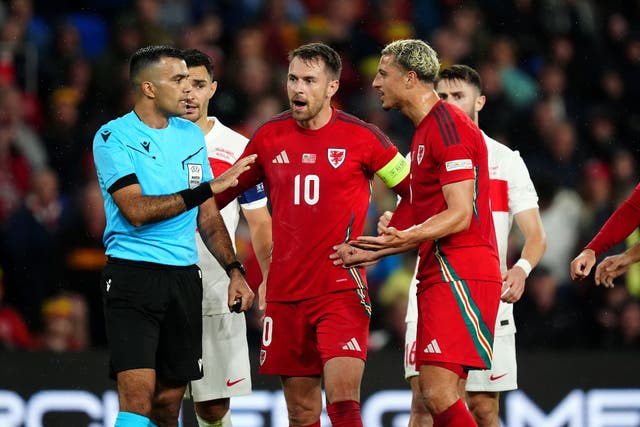 <p>Referee Rohit Saggi speaks to Wales pair Aaron Ramsey and Ethan Ampadu in the goalless Nations League draw with Turkey (David Davies/PA)</p>