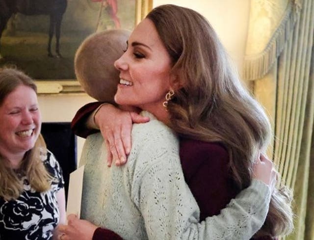 <p>Princess Kate embraces a teenager with cancer as she is pictured for the first time returning to work after chemotherapy</p>