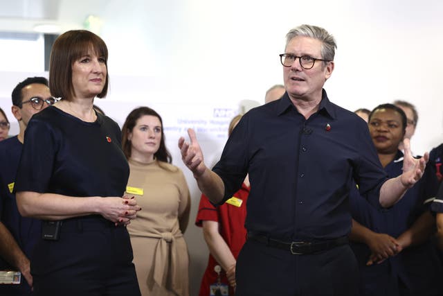 <p>Prime Minister Sir Keir Starmer and Chancellor Rachel Reeves speak to members of staff while visiting University Hospital Coventry and Warwickshire (Darren Staples/PA)</p>