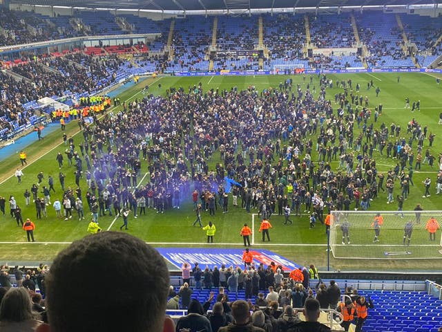 <p>Reading fans stormed the pitch in protest at the club’s owner </p>