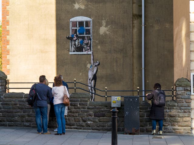 <p>Banksy’s ‘Well Hung Lover’ in Bristol</p>