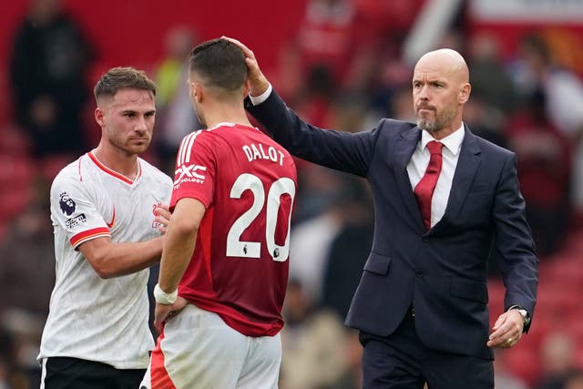 <p>Erik ten Hag consoles Manchester United defender Diogo Dalot at full-time</p>