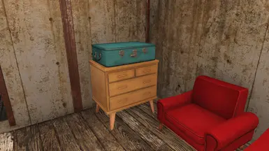 Small dresser and blue suitcase