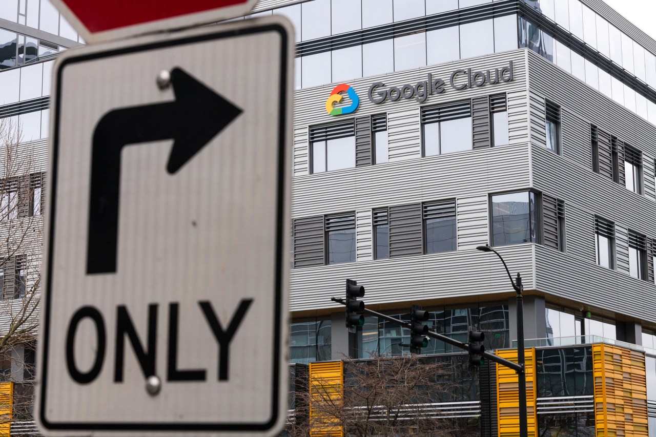 Seattle, USA - Feb 4, 2020: A right turn only street sign across the street from the new Google Cloud building entrance in the south lake union late in the day.