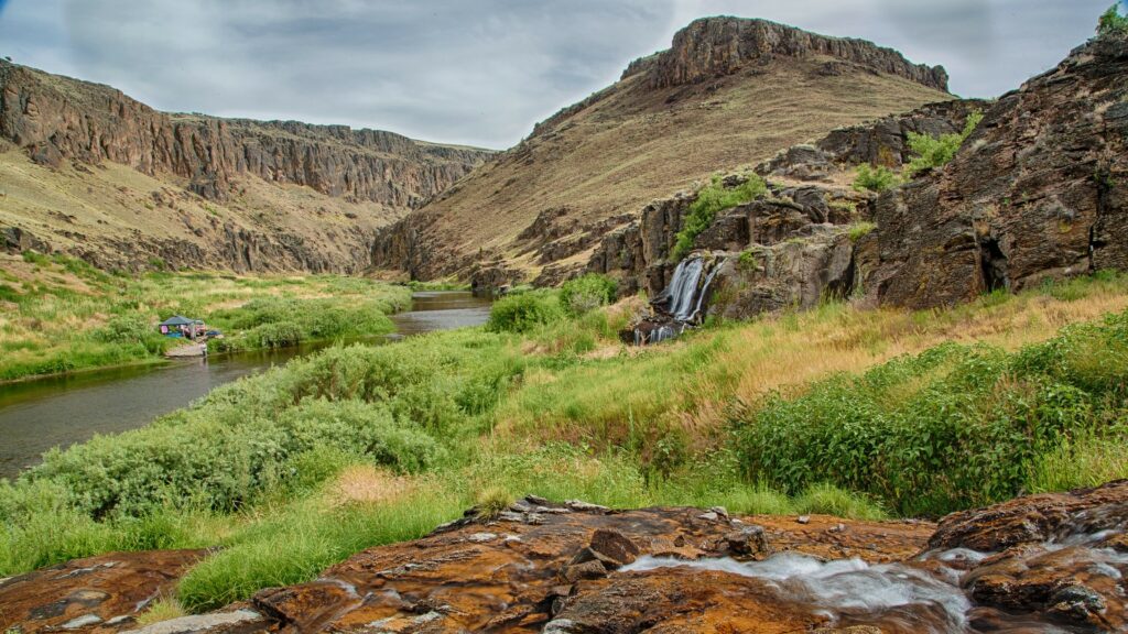 River winds through rocky canyon with grasses