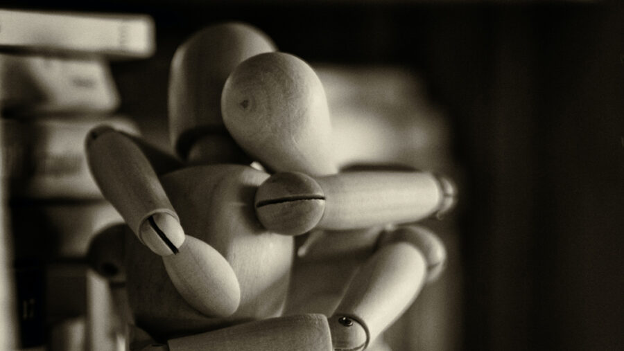 Two wooden dolls hugging each other