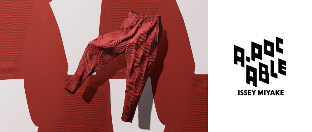 Left: TYPE-W 009 trousers in Dark Orange suspended mid-air. Background: A white sheet of trouser patten against red background. Right: A-POC ABLE ISSEY MIYAKE logo in black on white background.