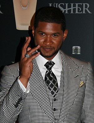 Usher mặc bộ áo vest tại một buổi ra mắt sản phẩm.