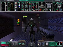 An in-game System Shock 2 gameplay screenshot, showcasing the interaction menus. A hand is holding a silver pistol while the mouse is pointed at an unknown robotic being, while on top of the screen several minor objects are shown organized as in inventory.