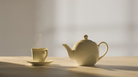 studio shot of making traditional british cup of tea using teapot 6