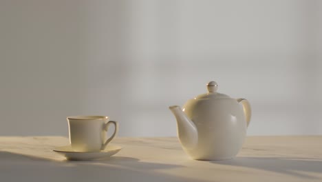 studio shot of making traditional british cup of tea using teapot 1