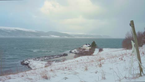 small house located by the shore in indre fosen, norway - wide shot