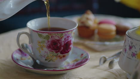 rack focus from pastries to a teacup being poured full